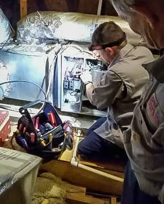 SS&L technician working on an inside air handler unit.