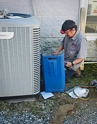 Technician works on an outdoor HVAC unit.